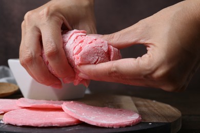 Photo of Woman making tasty mochi at wooden table, closeup