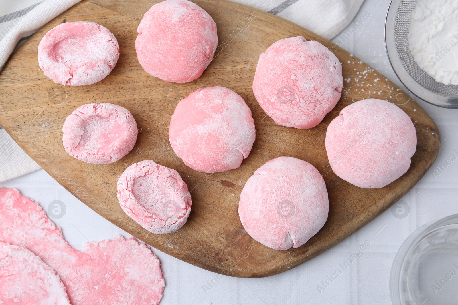 Photo of Tasty homemade mochi on white tiled table, top view