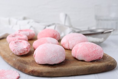 Photo of Tasty homemade mochi on white tiled table, closeup