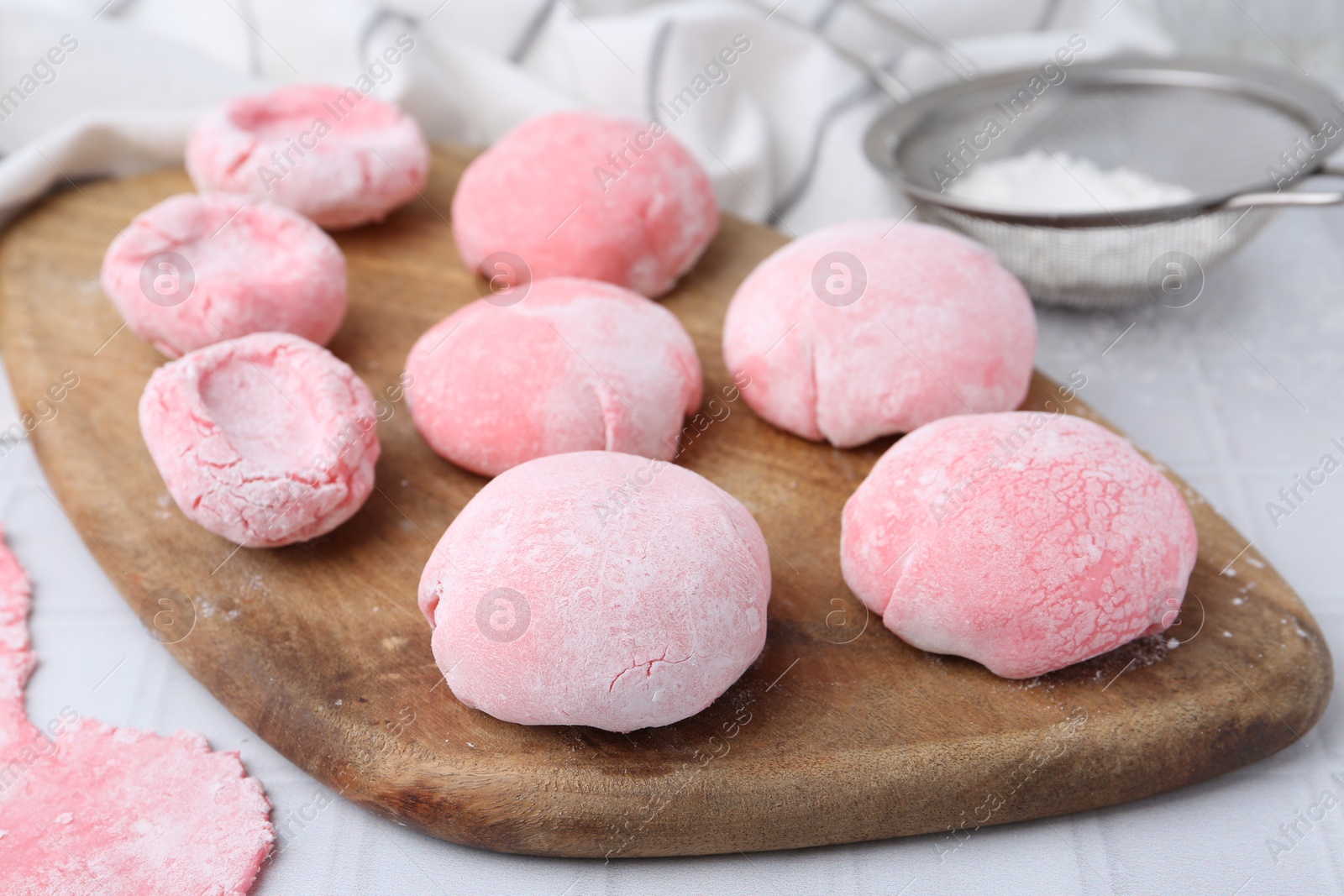 Photo of Tasty homemade mochi on white tiled table, closeup