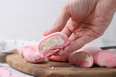 Photo of Woman making tasty mochi at white table, closeup