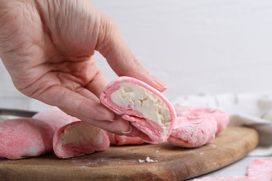 Photo of Woman making tasty mochi at white table, closeup