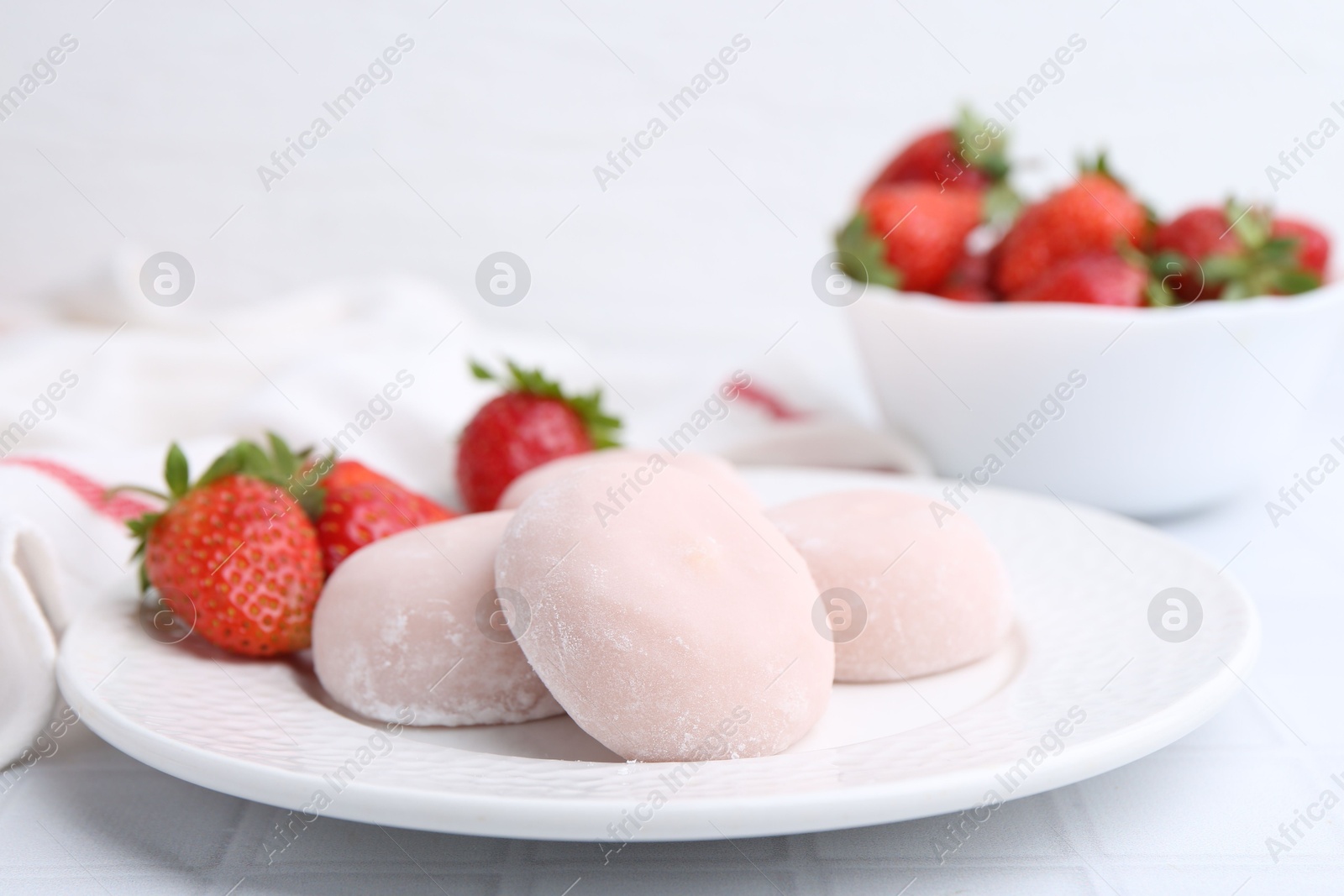 Photo of Delicious mochi and strawberries on table, closeup