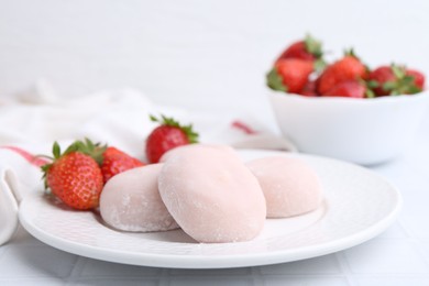 Delicious mochi and strawberries on table, closeup