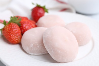 Photo of Delicious mochi and strawberries on plate, closeup