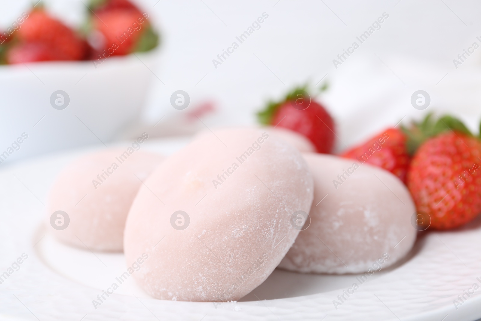 Photo of Delicious mochi and strawberries on plate, closeup