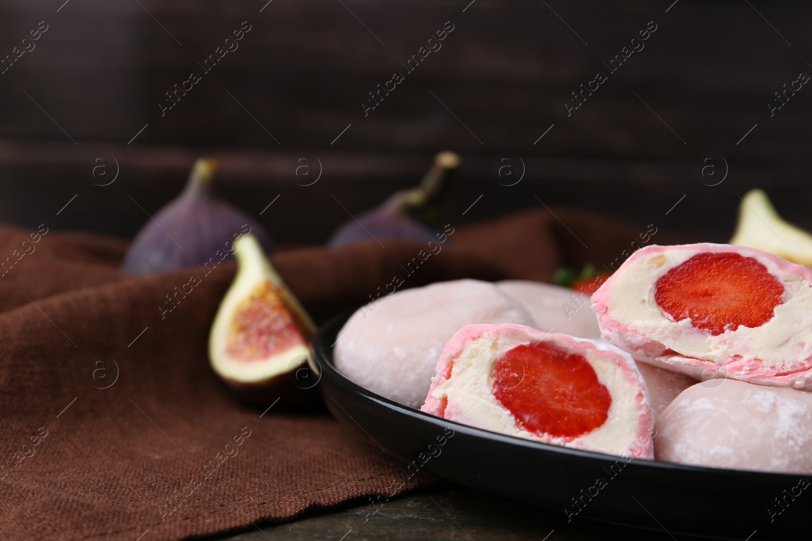 Photo of Delicious mochi with strawberries and figs on table, closeup