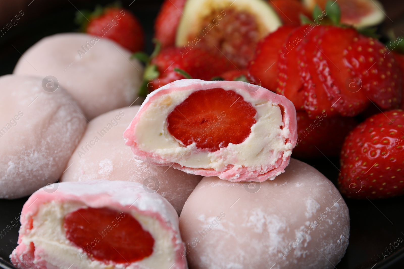 Photo of Delicious mochi with strawberries on plate, closeup