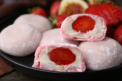 Photo of Delicious mochi with strawberries on table, closeup