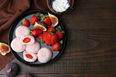 Delicious mochi with strawberries, figs and flour on wooden table, top view. Space for text