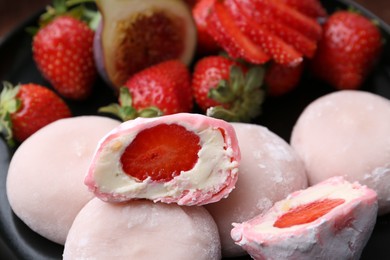 Photo of Delicious mochi with strawberries and fig on plate, closeup