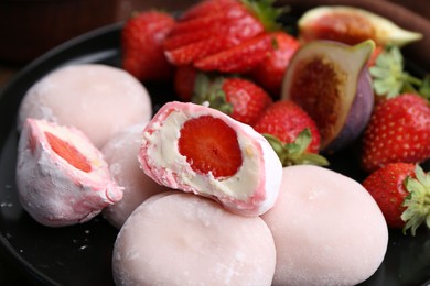 Delicious mochi with strawberries and fig on plate, closeup