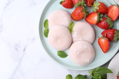 Delicious mochi with strawberries and mint on white marble table, top view. Space for text