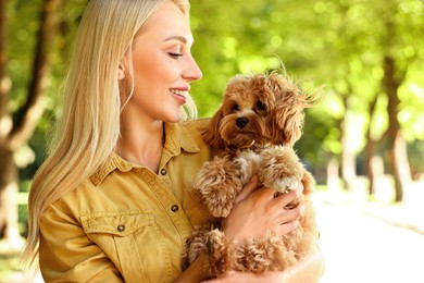 Photo of Beautiful young woman with cute dog in park