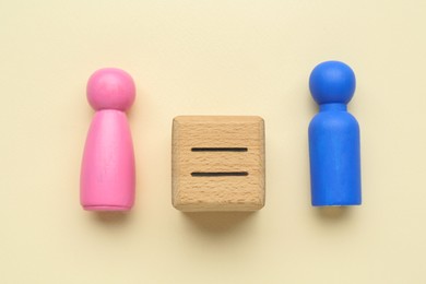 Photo of Gender equality concept. Male and female figures on beige background, flat lay