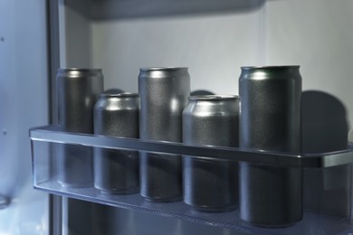 Photo of Many cans of beer in refrigerator, closeup