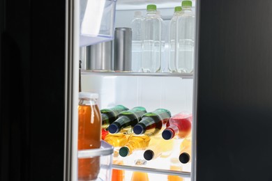 Many different cold drinks in refrigerator, closeup