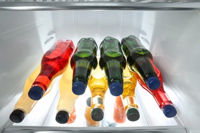 Many different cold drinks in refrigerator, closeup