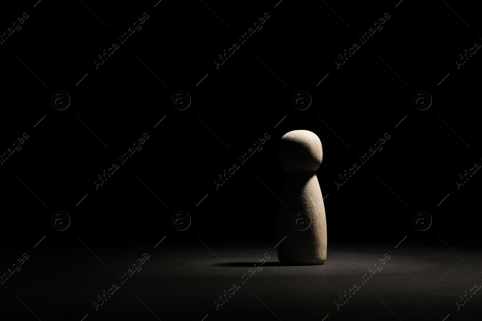 Photo of Loneliness concept. Human figure in darkness alone. Space for text