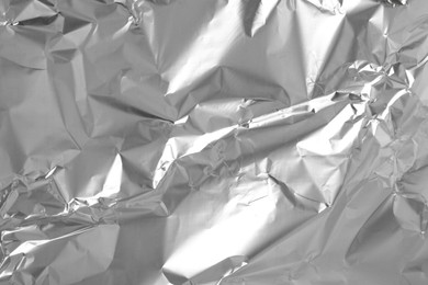 Photo of Shiny silver tinfoil surface as background, top view