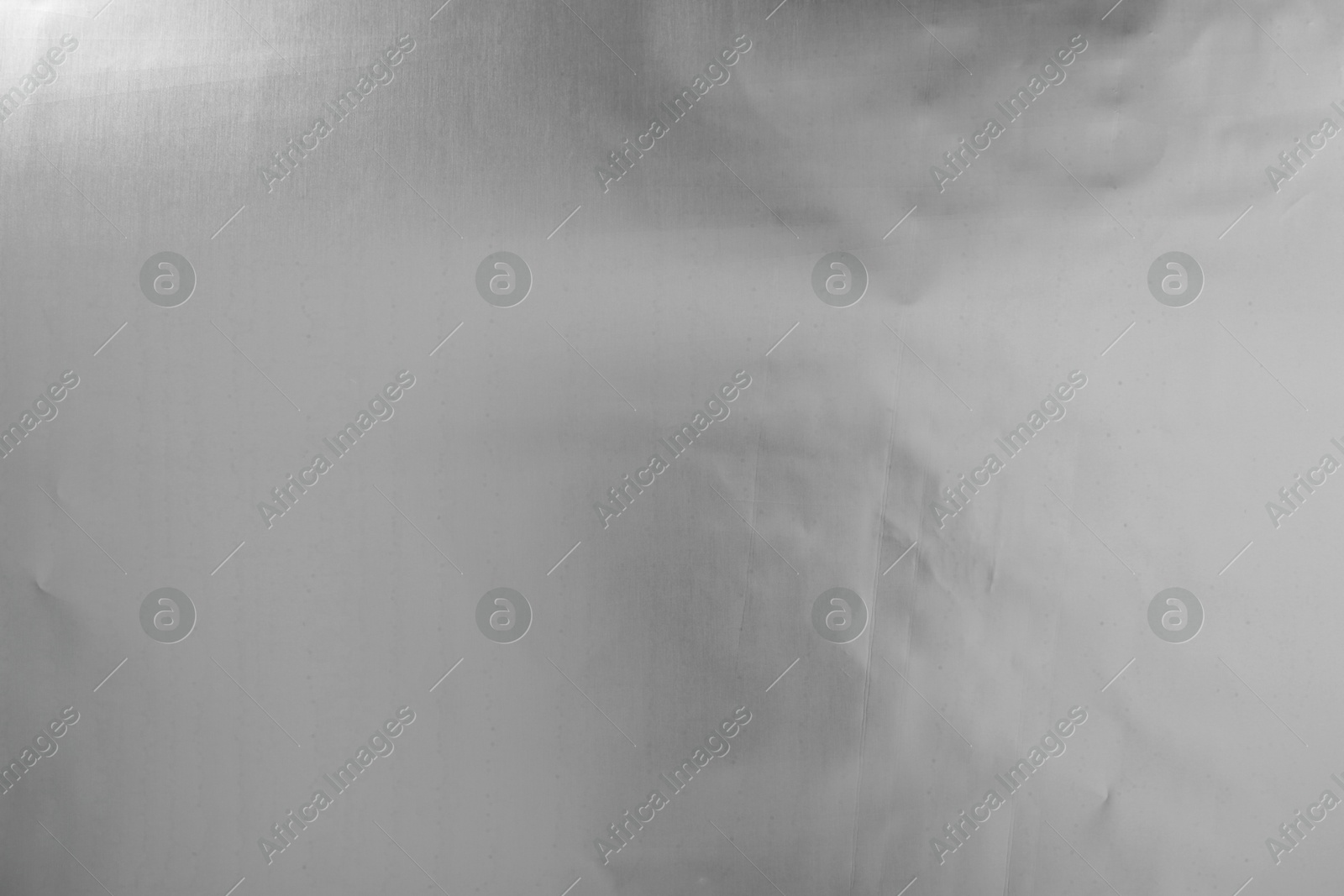 Photo of Shiny silver tinfoil surface as background, top view