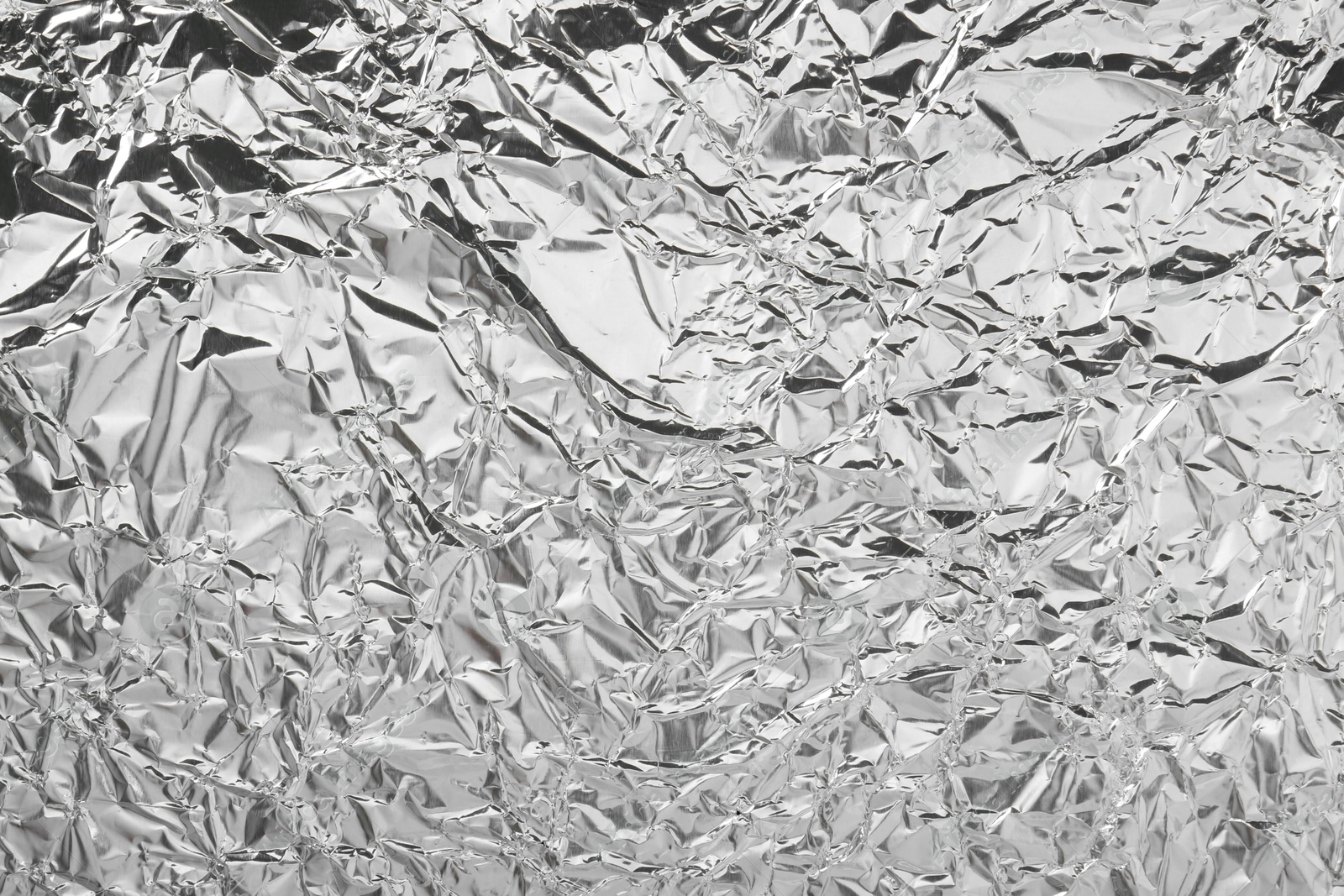 Photo of Shiny silver tinfoil surface as background, top view