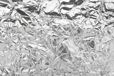 Shiny silver tinfoil surface as background, top view