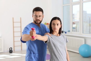 Photo of Patient exercising under physiotherapist supervision in rehabilitation center