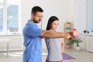 Photo of Patient exercising under physiotherapist supervision in rehabilitation center