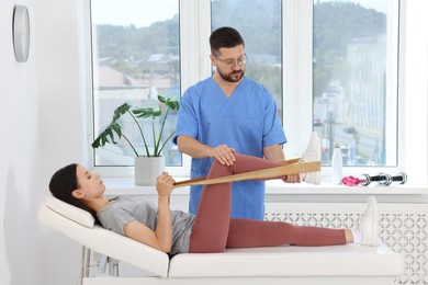 Physiotherapist working with patient in rehabilitation center