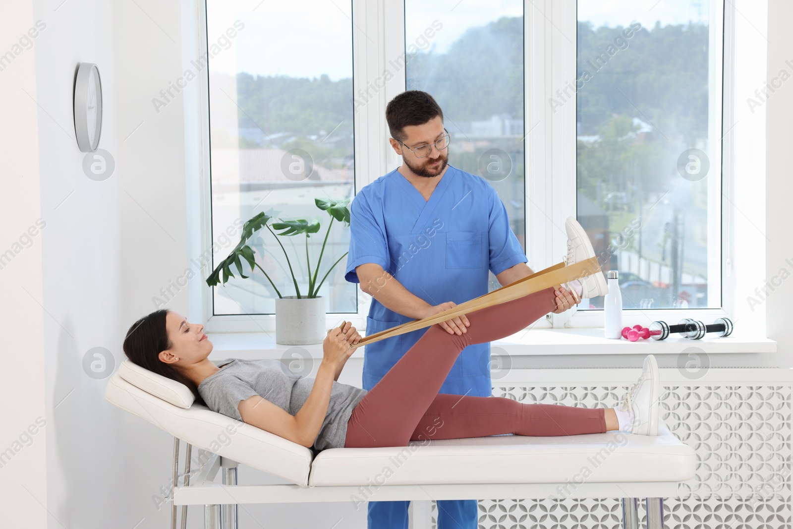 Photo of Physiotherapist working with patient in rehabilitation center