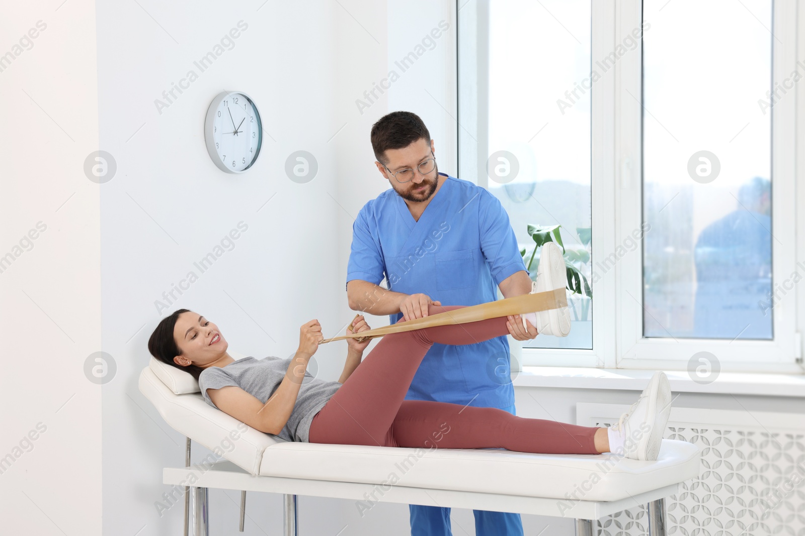 Photo of Physiotherapist working with patient in rehabilitation center