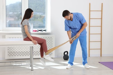 Physiotherapist working with patient in rehabilitation center