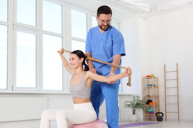 Photo of Patient exercising under physiotherapist supervision in rehabilitation center