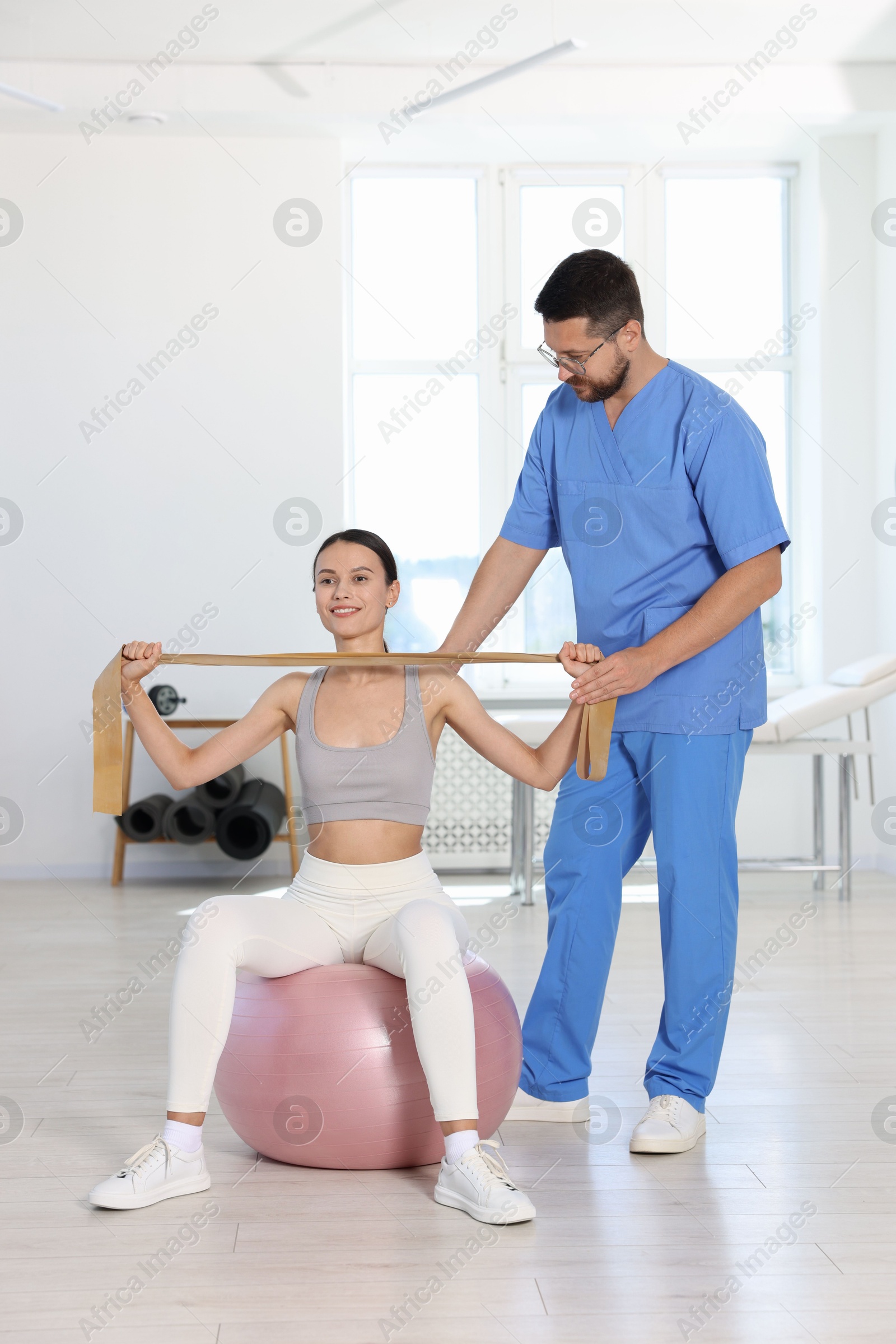 Photo of Patient exercising under physiotherapist supervision in rehabilitation center