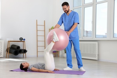 Physiotherapist working with patient in rehabilitation center