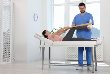 Physiotherapist working with patient in rehabilitation center