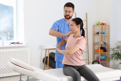 Photo of Physiotherapist working with patient in rehabilitation center