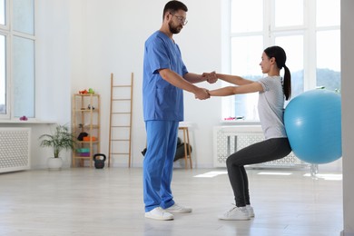 Physiotherapist working with patient in rehabilitation center