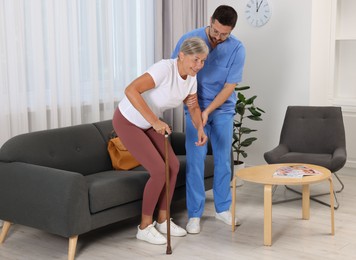 Rehabilitation. Physiotherapist working with senior patient indoors