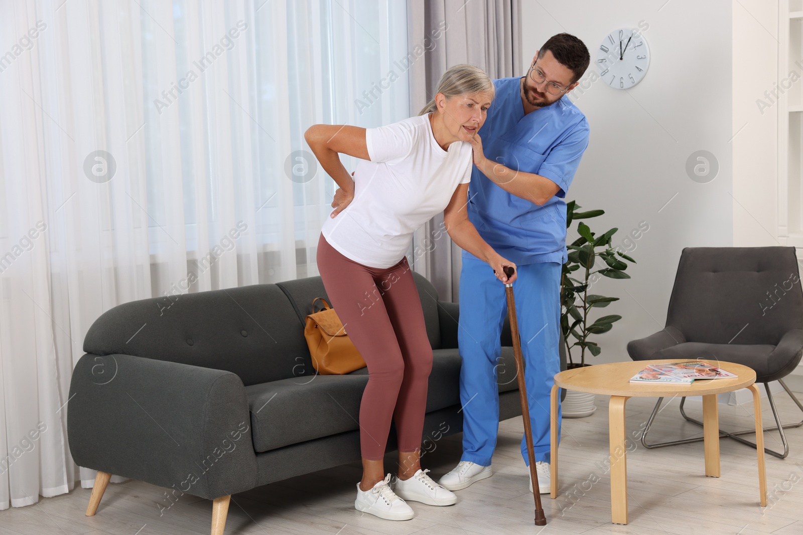 Photo of Rehabilitation. Physiotherapist working with senior patient indoors