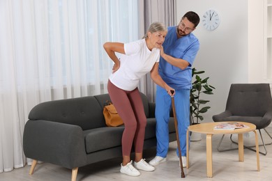 Rehabilitation. Physiotherapist working with senior patient indoors