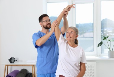 Physiotherapist working with senior patient in rehabilitation center