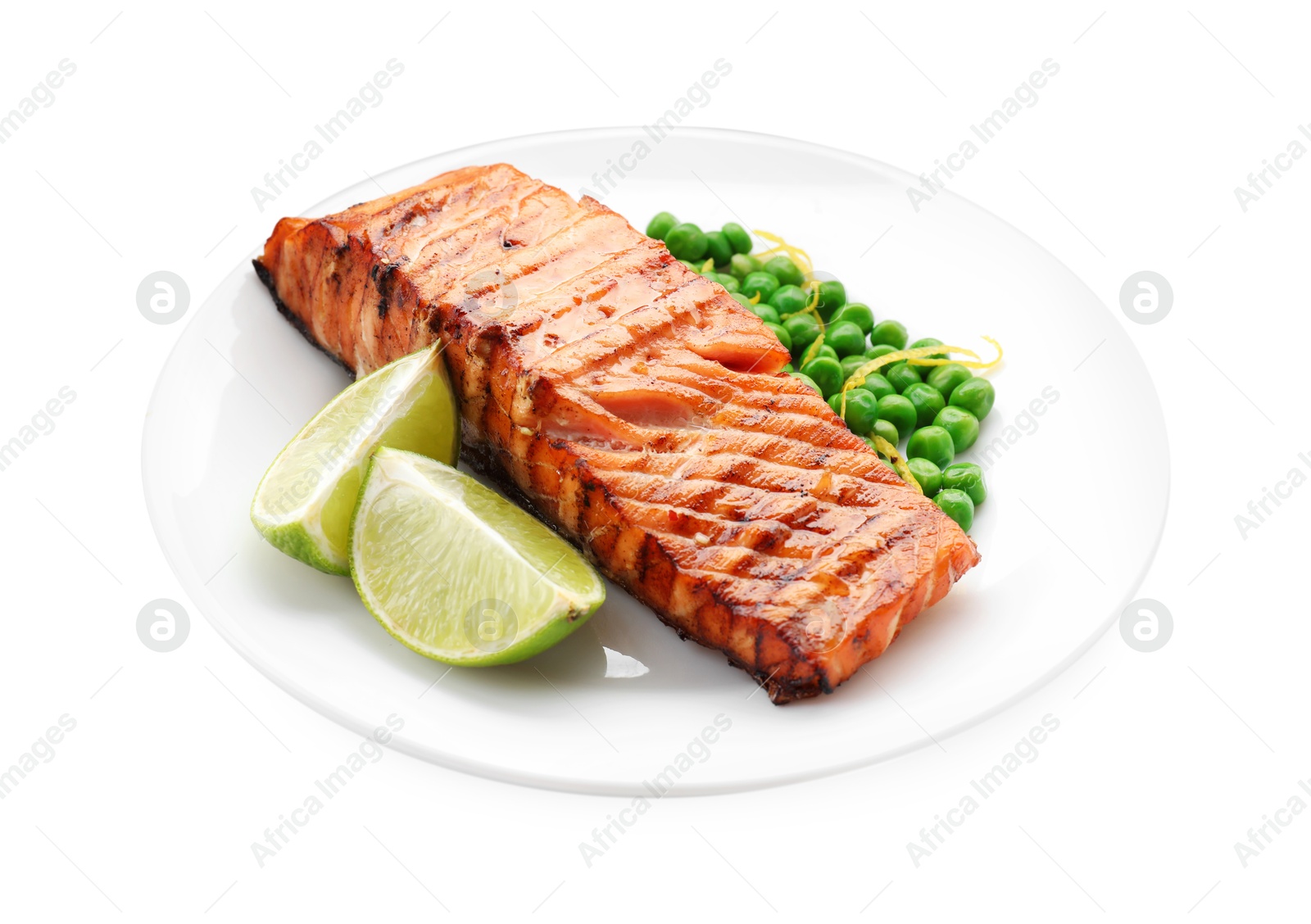 Photo of Delicious grilled salmon fillet with green peas and lime isolated on white