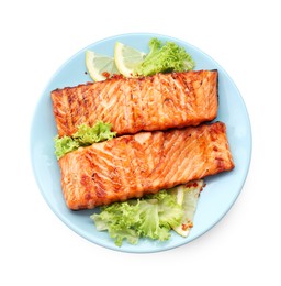 Photo of Delicious grilled salmon fillets with lettuce and lemon isolated on white, top view