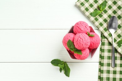 Photo of Scoops of tasty watermelon sorbet with mint in bowl and spoon on white wooden table, flat lay. Space for text