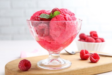 Photo of Delicious raspberry sorbet, mint and fresh berries on white wooden table, closeup