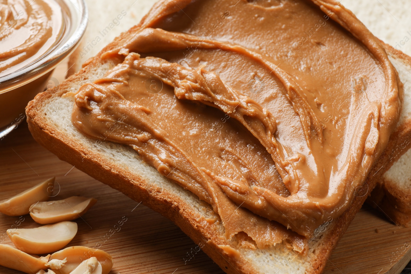 Photo of Delicious sandwich with peanut butter and nuts on table, closeup