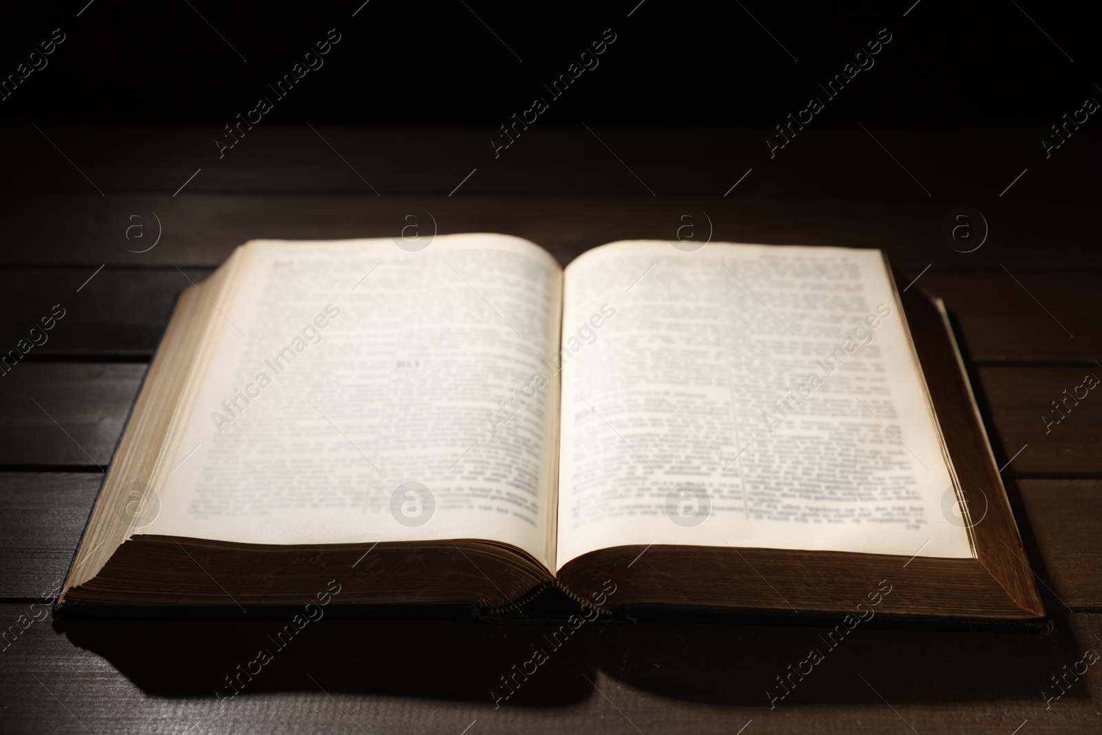 Photo of Open Bible on wooden table. Christian faith