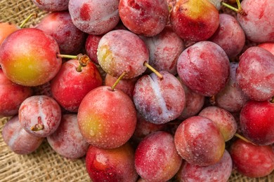 Photo of Tasty ripe plums on table, flat lay